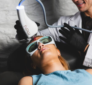 A woman wears glasses as she receives hyperpigmentation treatment in Upper East Side, NYC