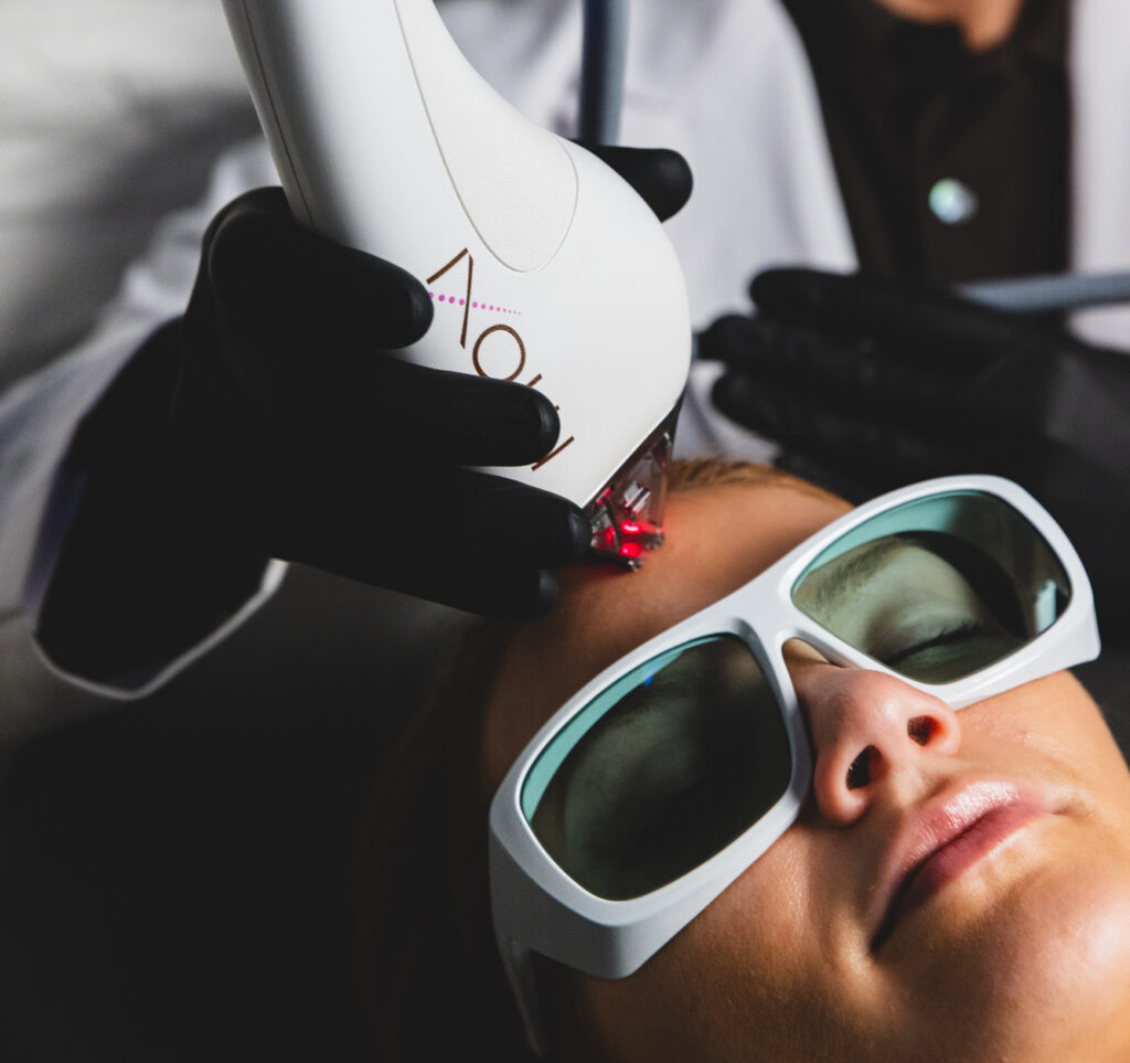 A woman wearing protective eyewear receives a treatment for laser skin resurfacing in New York City.
