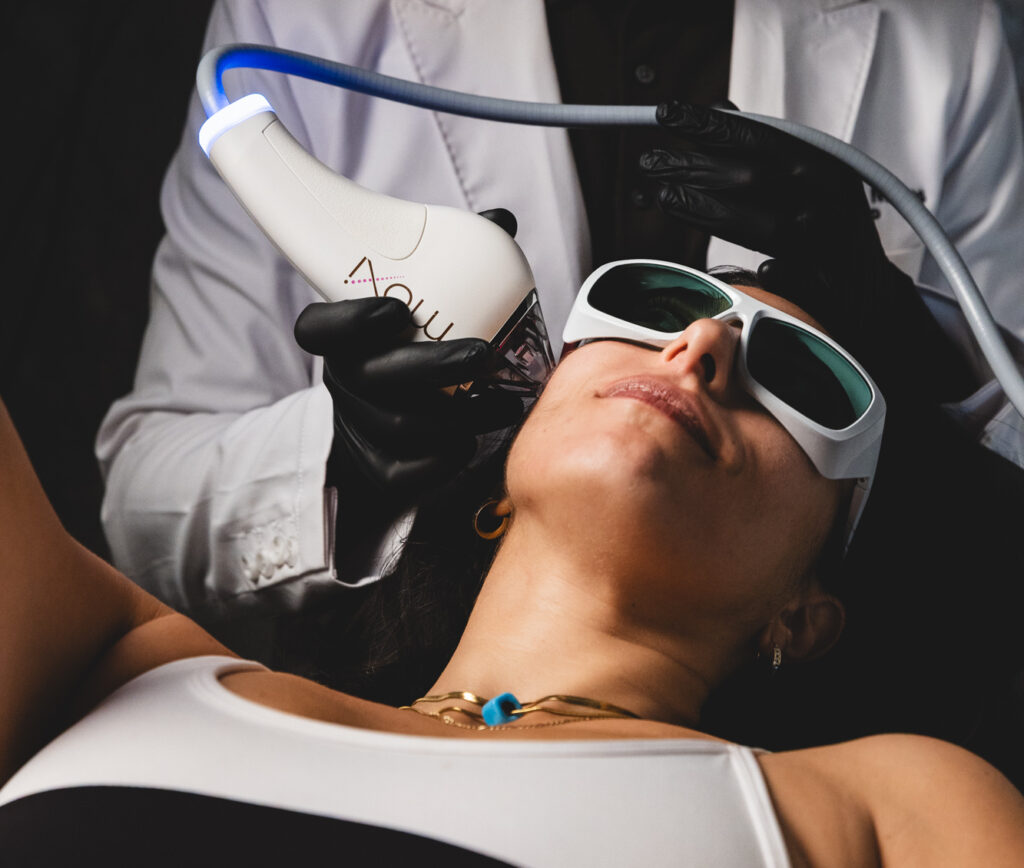 A woman lies back and enjoys a melasma treatment in Upper East Side, NYC